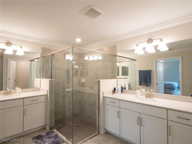 bathroom featuring a shower with door, ornamental molding, vanity, and tile patterned floors