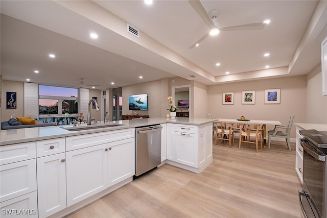 kitchen featuring kitchen peninsula, white cabinetry, dishwasher, and sink