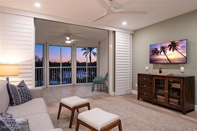 living room with ceiling fan and light hardwood / wood-style floors