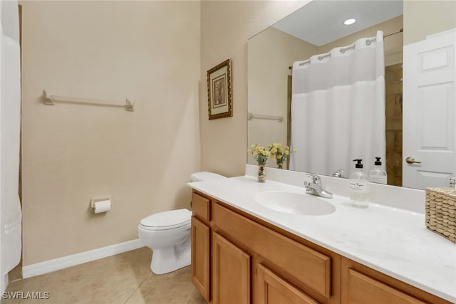 bathroom with tile patterned flooring, vanity, and toilet