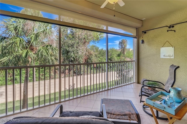 sunroom / solarium featuring ceiling fan