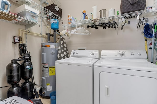 laundry room with separate washer and dryer and water heater