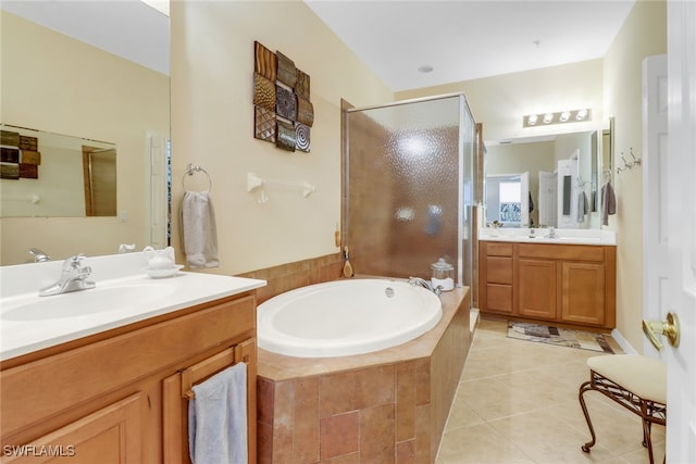 bathroom with tile patterned floors, separate shower and tub, and vanity