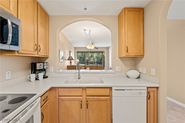 kitchen featuring sink, white appliances, and light tile patterned floors