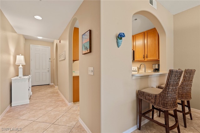 corridor with light tile patterned flooring