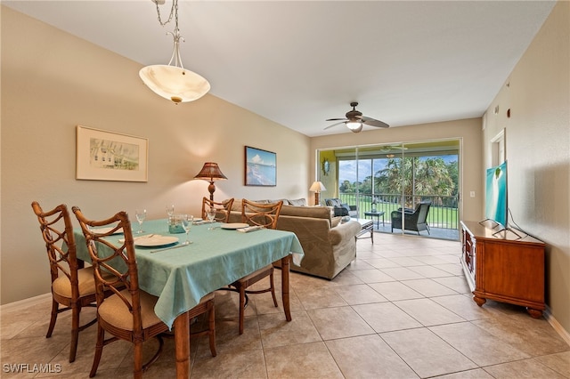 dining area with light tile patterned flooring, baseboards, and a ceiling fan