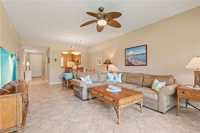 living room featuring light tile patterned floors and ceiling fan