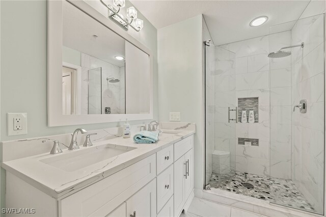 bathroom featuring walk in shower and vanity