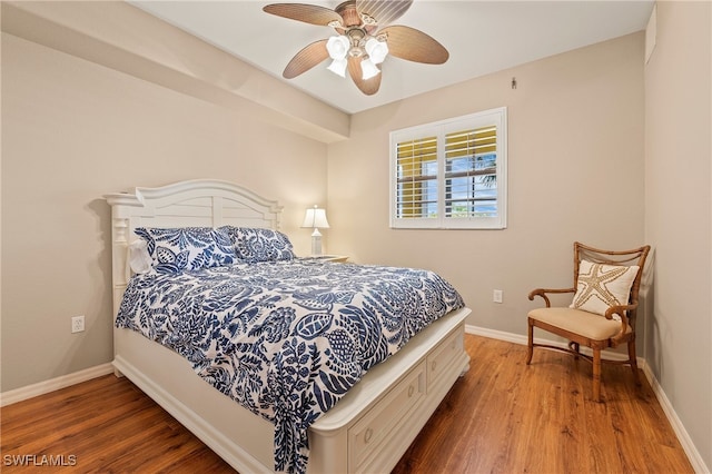 bedroom with hardwood / wood-style floors and ceiling fan