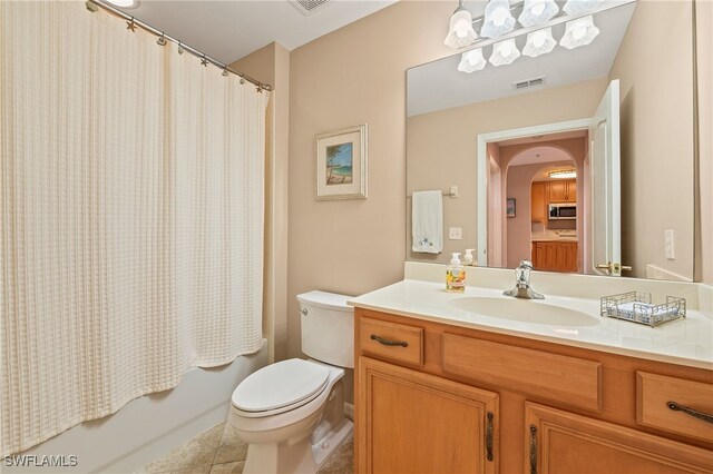 full bathroom featuring vanity, shower / tub combo with curtain, tile patterned floors, and toilet