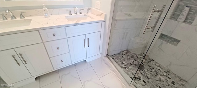 bathroom with a shower with door and vanity