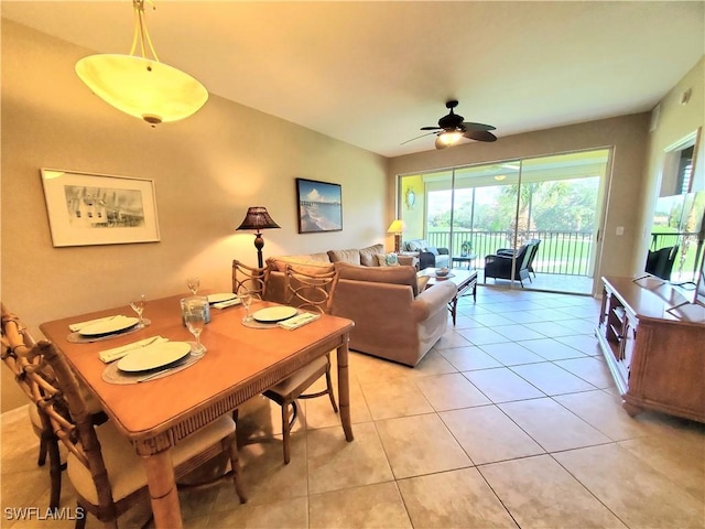 tiled dining space featuring ceiling fan