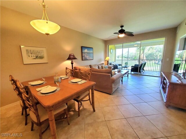 dining area with light tile patterned floors and ceiling fan