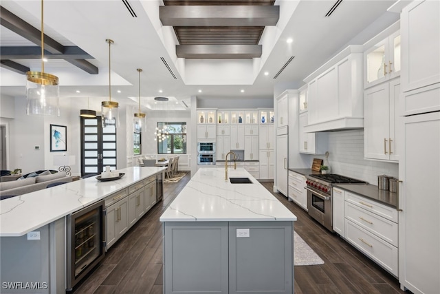 kitchen with white cabinetry, wine cooler, high end appliances, and a spacious island