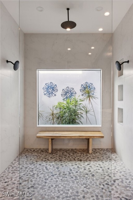 bathroom with a tile shower