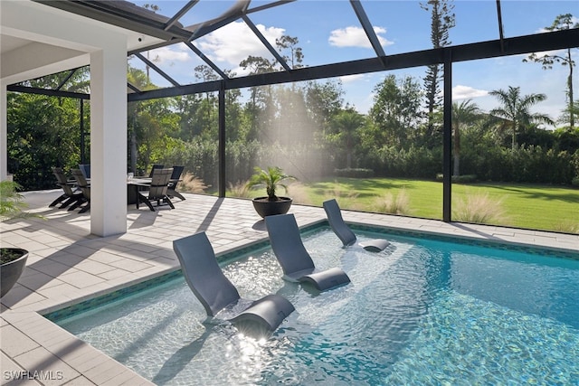 view of swimming pool with a patio area, a lanai, and a lawn