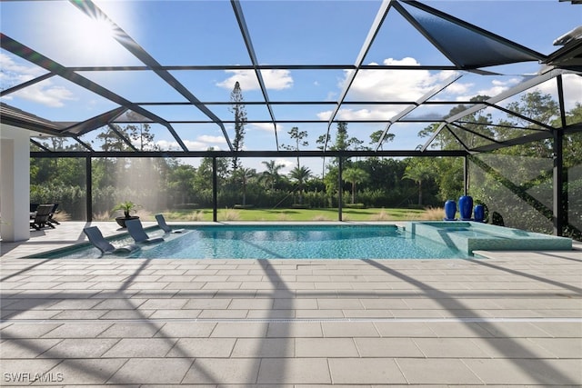 view of swimming pool featuring a lanai and a patio