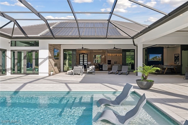 view of pool with french doors, glass enclosure, ceiling fan, and a patio area