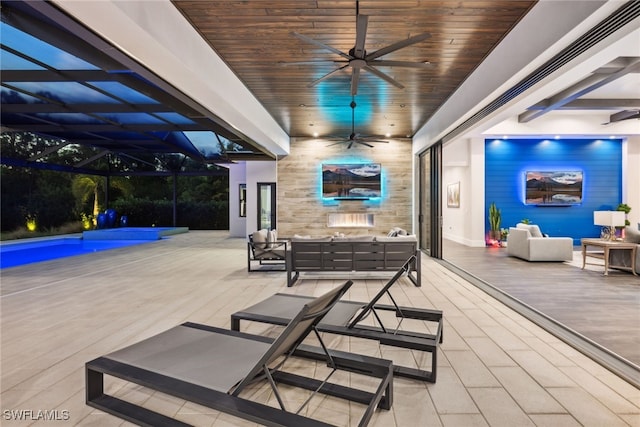 view of patio / terrace featuring a lanai, ceiling fan, and an outdoor hangout area