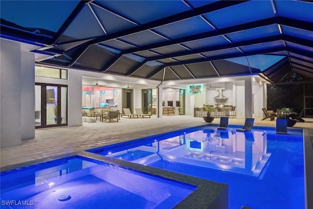 view of swimming pool featuring a lanai, a patio area, an in ground hot tub, and a bar