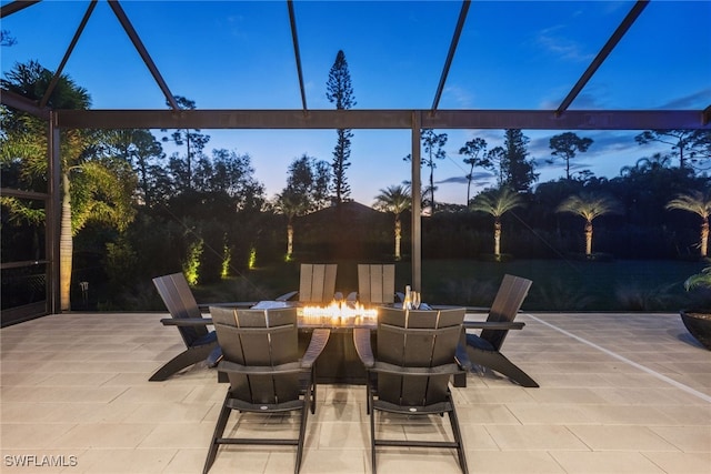 patio terrace at dusk featuring an outdoor fire pit