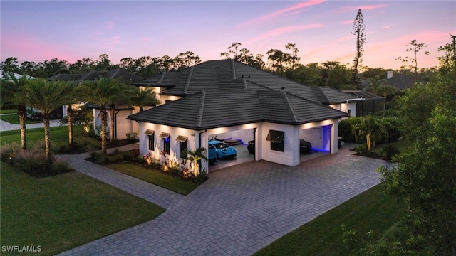 view of front of home featuring a lawn and a garage