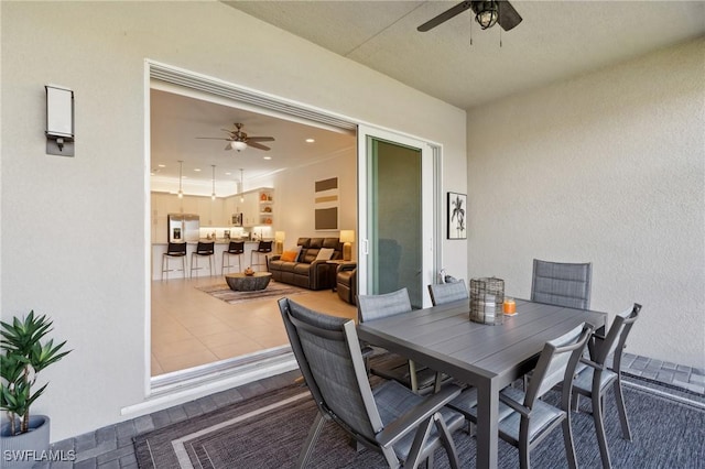 view of patio featuring outdoor dining area and a ceiling fan