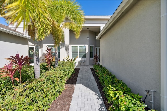 property entrance with stucco siding