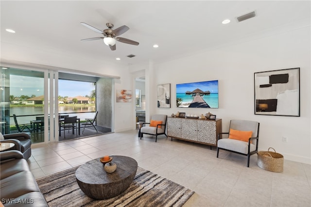 living room with ceiling fan, a water view, and light tile patterned floors