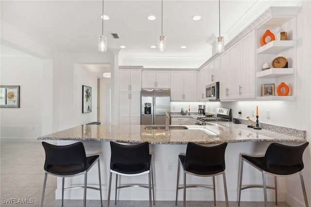 kitchen with a sink, light stone countertops, a peninsula, stainless steel appliances, and open shelves