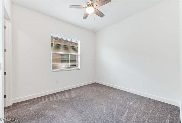 carpeted empty room featuring a ceiling fan and baseboards