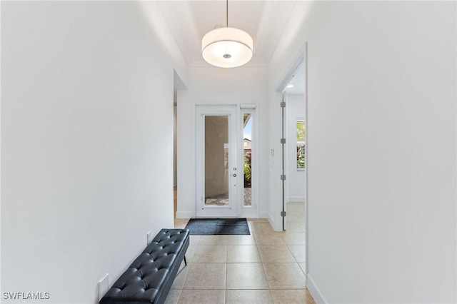 entryway with light tile patterned floors and baseboards