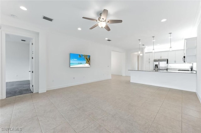 unfurnished living room with visible vents, recessed lighting, baseboards, and a ceiling fan