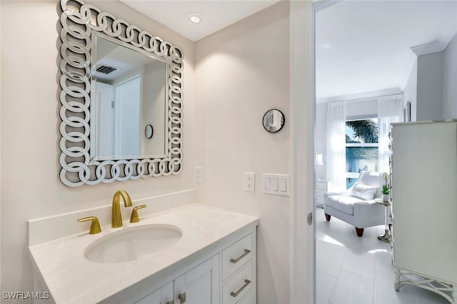 bathroom with vanity and ornamental molding