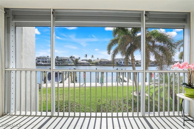 unfurnished sunroom featuring a water view