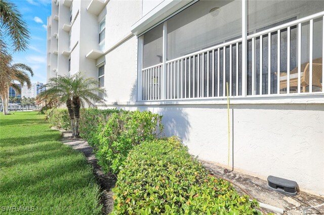 view of side of property with a yard