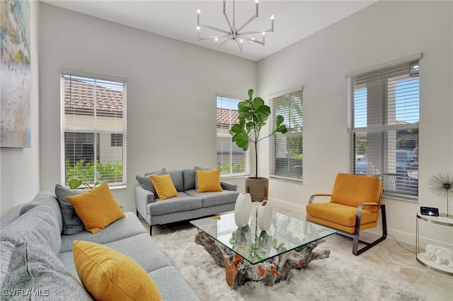 living room with a notable chandelier, a healthy amount of sunlight, and light tile patterned floors