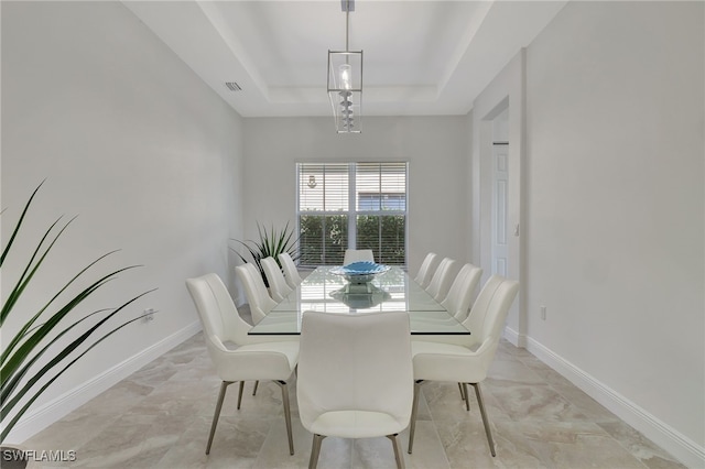 dining space with a tray ceiling