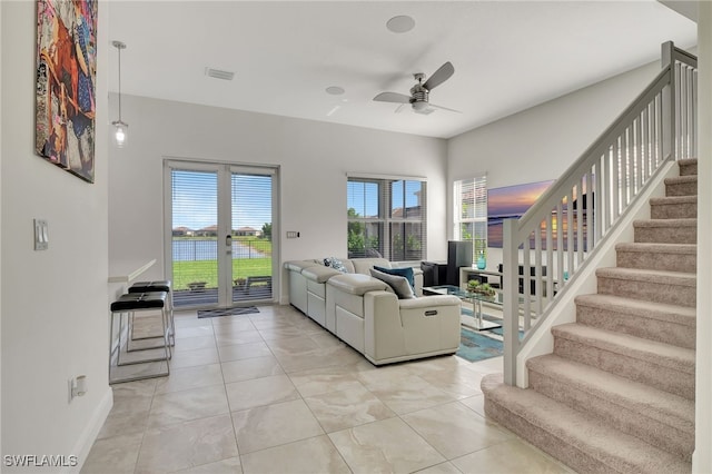 living room with light tile patterned floors, french doors, and ceiling fan