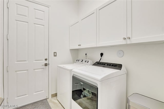 laundry area with cabinets and washer and clothes dryer