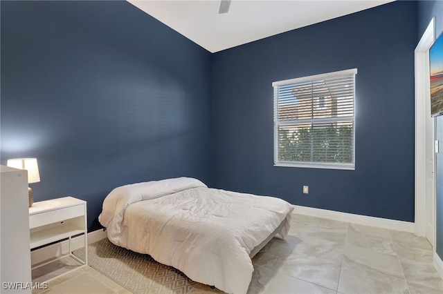 bedroom featuring ceiling fan and light tile patterned flooring