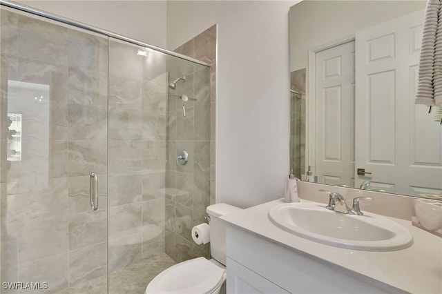 bathroom with vanity, toilet, and walk in shower