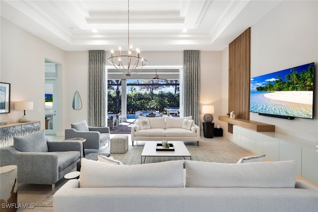 interior space with a raised ceiling, a towering ceiling, and an inviting chandelier