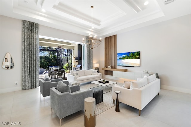 tiled living room featuring a tray ceiling and a notable chandelier