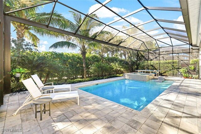 view of swimming pool with a lanai, a patio, and an in ground hot tub