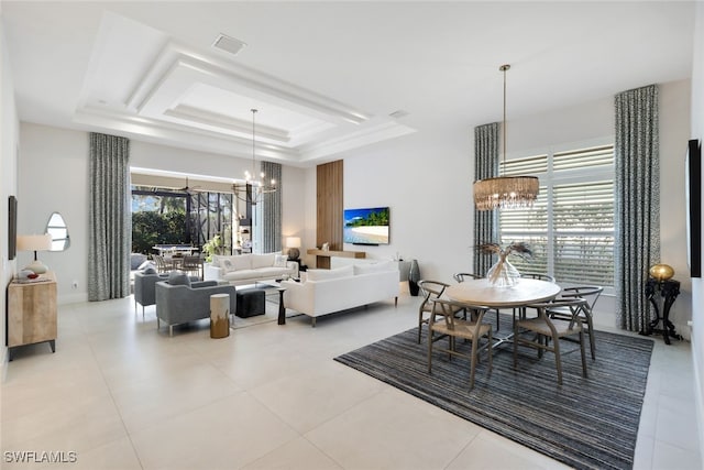 dining area with a raised ceiling, light tile patterned flooring, a wealth of natural light, and a chandelier