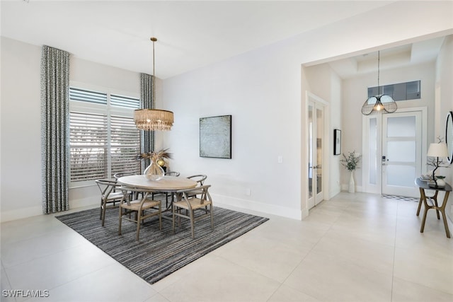 dining room featuring an inviting chandelier and light tile patterned floors