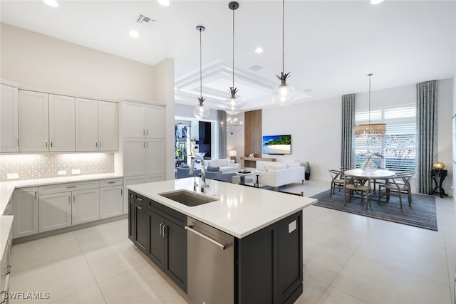 kitchen with a center island with sink, dishwasher, sink, and pendant lighting