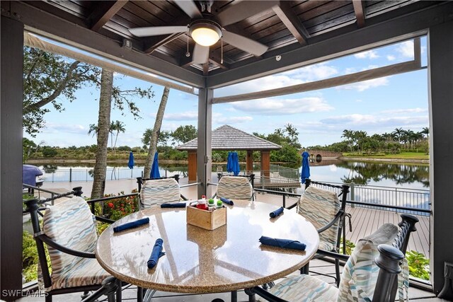 view of patio with a gazebo, a water view, and ceiling fan