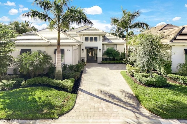 mediterranean / spanish-style home with a front lawn